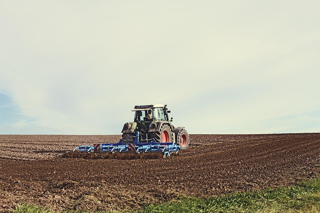expansive green agricultural fields tractor working rich soil French countryside