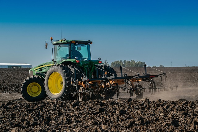 farm technician operating modern agricultural machinery tractor